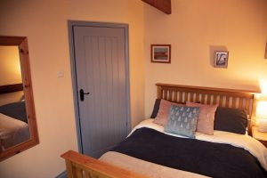 60 Old Barn main bedroom bed door 1 300x200